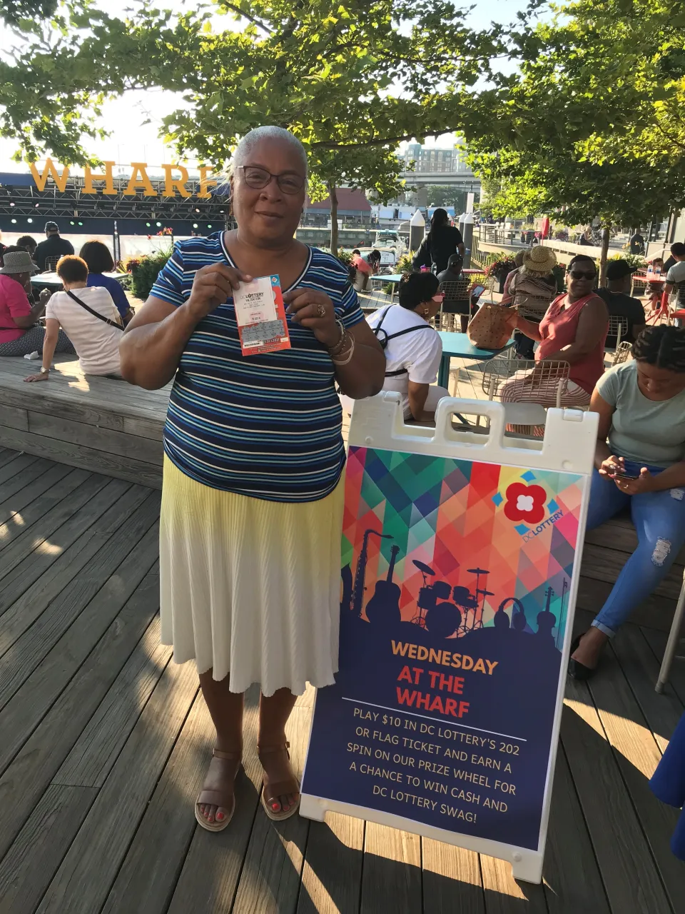 Woman posing for a photo with winning scratcher